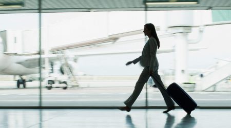 Businesswoman with suitcase in airport